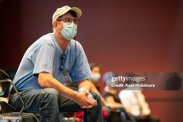 People at a COVID19 vaccine clinic the International Union of Operating Engineers Local 399 union hall listen to Vice President Kamala Harris speak...