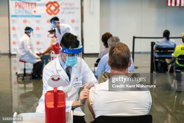 An unidentified man gets a a Johnson and Johnson COVID19 vaccine ahead of Vice President Kamala Harris touring a COVID19 vaccination site at the...