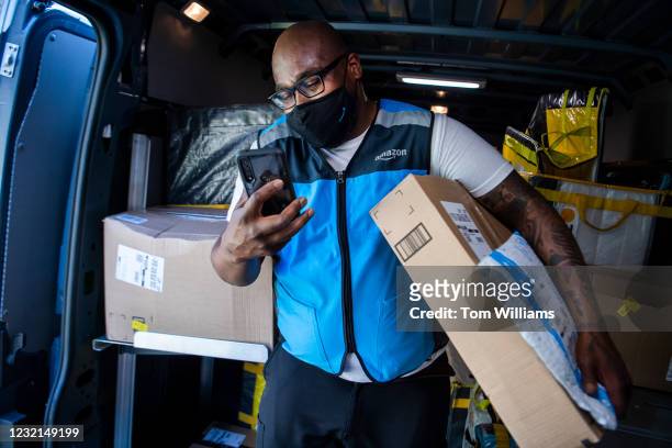 Amazon driver Shawndu Stackhouse delivers packages in Northeast Washington, D.C., on Tuesday, April 6, 2021.