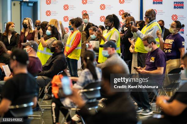 People watch as Vice President Kamala Harris tours a COVID19 vaccination site at the International Union of Operating Engineers Local 399 union hall...
