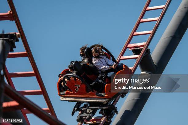 People wearing face masks to stop the spread of coronavirus enjoying a roller coaster in the Amusement Park of Madrid. The park has adapted and...