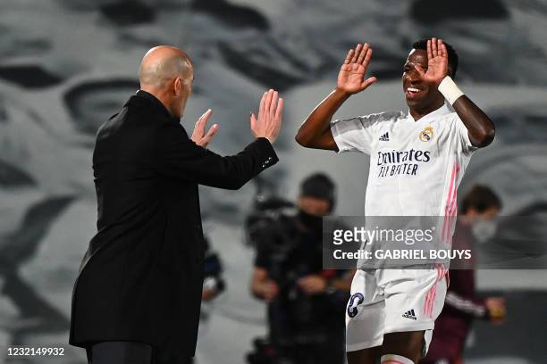 Real Madrid's Brazilian forward Vinicius Junior celebrates with Real Madrid's French coach Zinedine Zidane after scoring a goal during the UEFA...