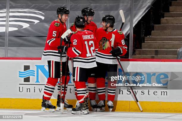 Kirby Dach of the Chicago Blackhawks celebrates with teammates after scoring a goal in the first period against the Dallas Stars at the United Center...