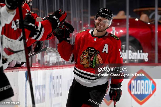 Alex DeBrincat of the Chicago Blackhawks celebrates with teammates after scoring a goal in the second period against the Dallas Stars at the United...