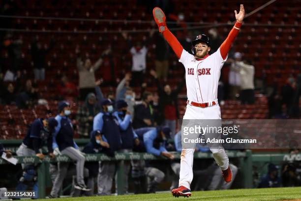 Alex Verdugo celebrates as he scores after J.D. Martinez of the Boston Red Sox hits a walk off two-run shot in the twelfth inning of a game against...