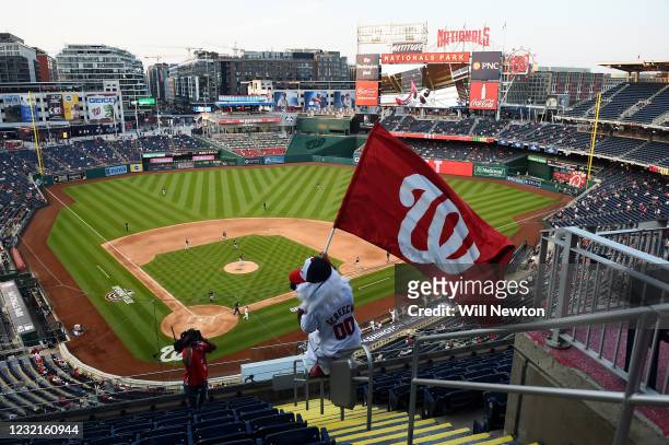 Washington Nationals mascot Screech is seen waving a Nationals flag to pump up the crowd on the scoreboard during the game between the Atlanta Braves...