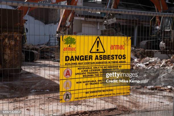 Danger Asbestos sign on a construction / demolition site on 30th March 2021 in Birmingham, United Kingdom. Asbestos is a naturally occurring fibrous...