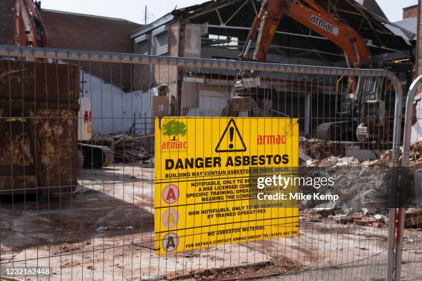 Danger Asbestos sign on a construction / demolition site on 30th March 2021 in Birmingham, United Kingdom. Asbestos is a naturally occurring fibrous...