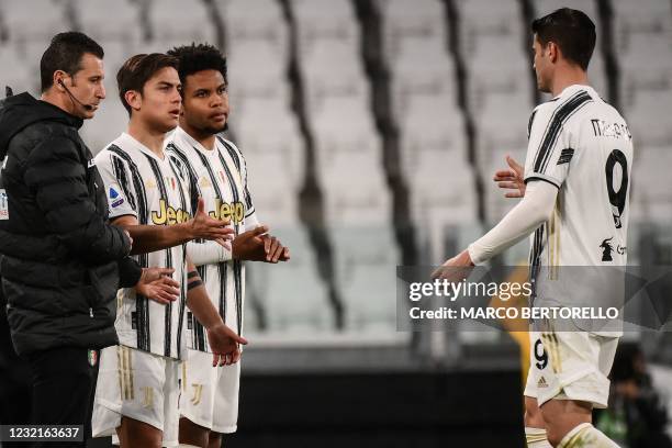 Juventus' Argentine forward Paulo Dybala and Juventus' American midfielder Weston McKennie enter the pitch as Juventus' Spanish forward Alvaro Morata...