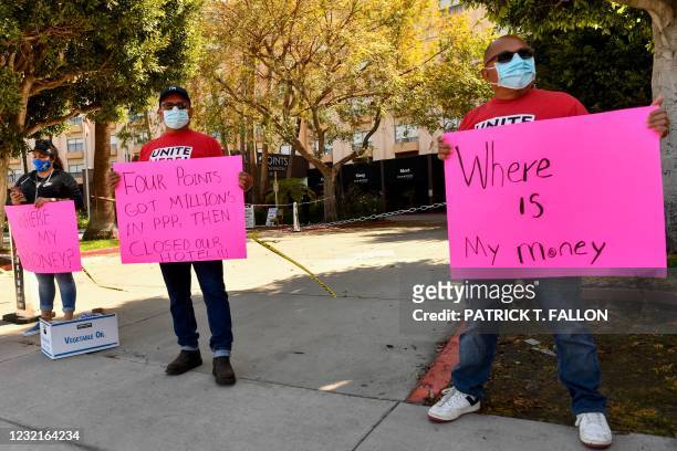 Laid-off employees and workers with Unite Here 11 protest outside the closed Four Points by Sheraton LAX hotel as they call for an investigation by...