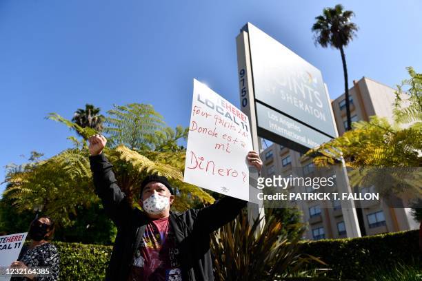Laid-off employees and workers with Unite Here 11 protest outside the closed Four Points by Sheraton LAX hotel as they call for an investigation by...