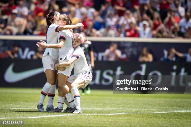 Tobin Heath of United States gets congratulated by teammates Captain Alex Morgan of United States and Megan Rapinoe of United States with the Nike...