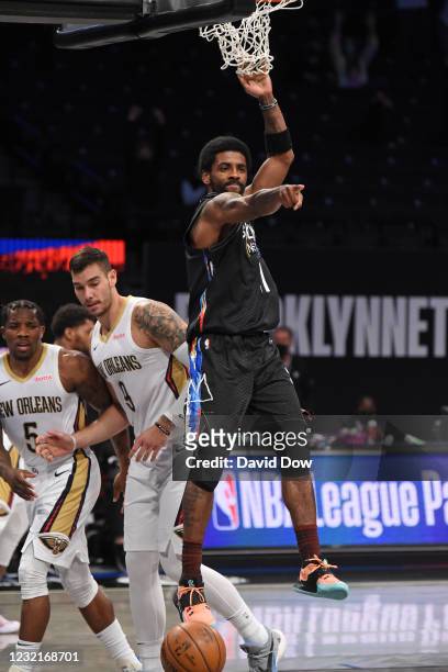 Kyrie Irving of the Brooklyn Nets reacts after dunking the ball against the New Orleans Pelicans on April 7, 2021 at Barclays Center in Brooklyn, New...