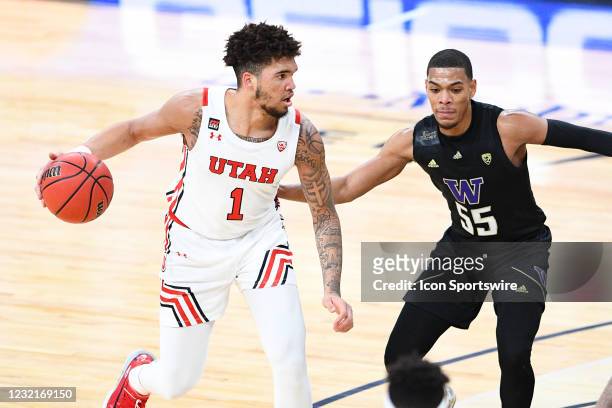 Utah Utes forward Timmy Allen guarded closely by Washington Huskies guard Quade Green during the first round game of the men's Pac-12 Tournament...