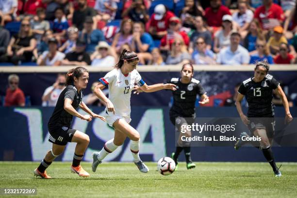 Team Captain Alex Morgan of United States outruns a sea of Mexican team defenders with the VISA logo behind her during the International Friendly...