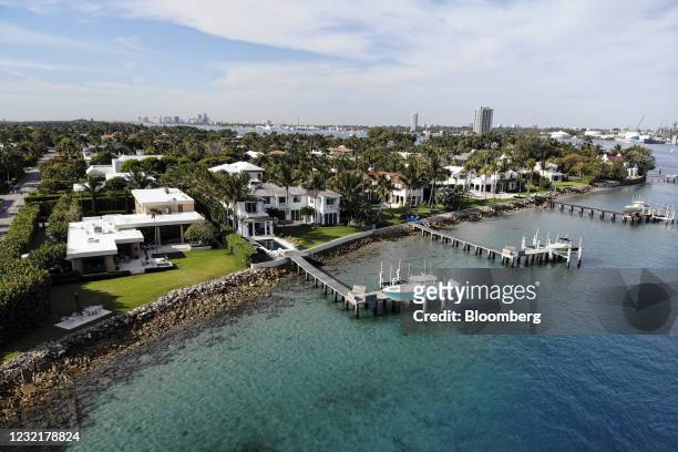 Boats docked next to single-family houses in Palm Beach, Florida, U.S., on Wednesday, April 7, 2021. Purchase contracts for single-family houses...