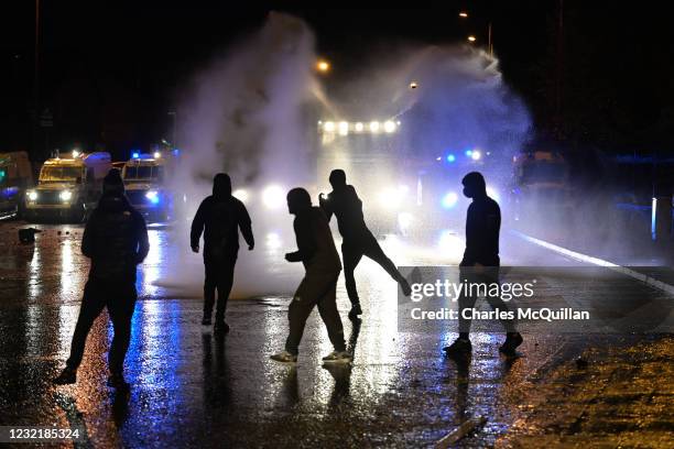 Nationalists attack police vehicles as they deploy water canons on Springfield Road just up from Peace Wall interface gates which divide the...