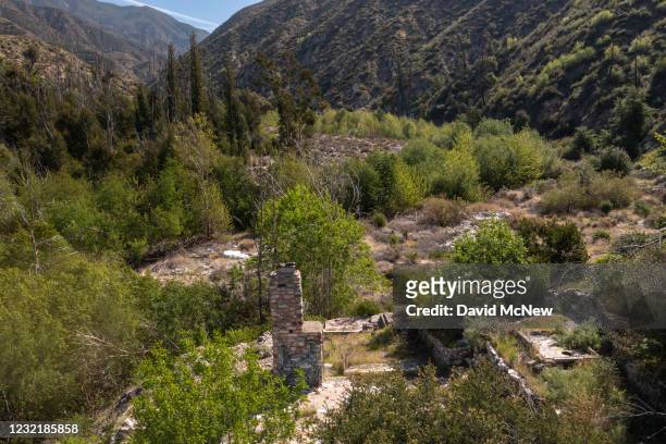 In an aerial view, the ruins of a home next to the West Fork of the San Gabriel River that was destroyed by the 2002 Curve-Williams Complex fire is...
