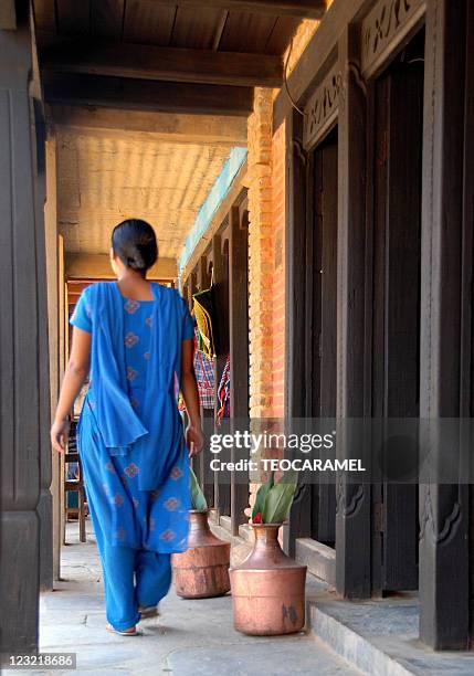 woman in blue traditional dress walking in corrido - salwar stock pictures, royalty-free photos & images