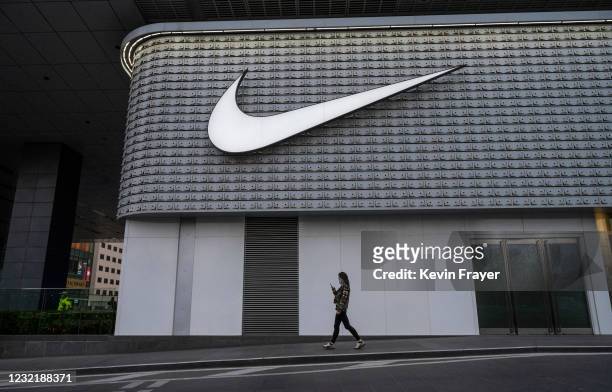 Woman walks outside a Nike store at a shopping area on April 8, 2021 in Beijing, China.