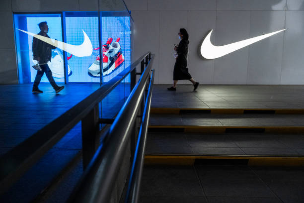 People walk outside a Nike store at a shopping area on April 8, 2021 in Beijing, China.
