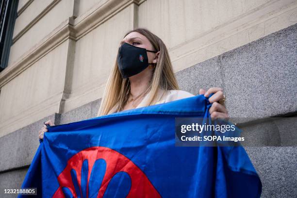 Woman holds a gypsy flag during the demonstration. As part of the International Day of the Gypsy People, the Gypsy community in Madrid demonstrate on...