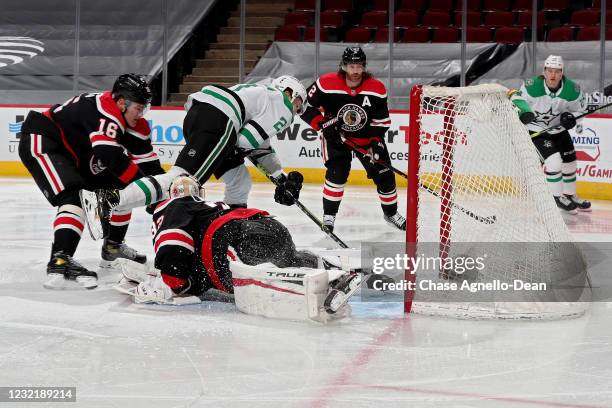 Jason Robertson of the Dallas Stars scores a goal past Nikita Zadorov and Kevin Lankinen of the Chicago Blackhawks in the second period at the United...