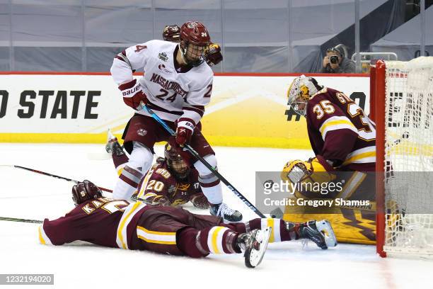 Zach Stejskal of the Minnesota Duluth Bulldogs makes a save on a shot attempt by Zac Jones of the Massachusetts Minutemen during the Division I Men's...