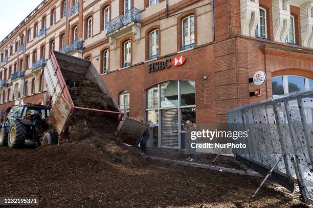 Farmer discharges manure near riot police. Several hundreds of farmers gathered in Toulouse with their tractors and with manure to protest against...