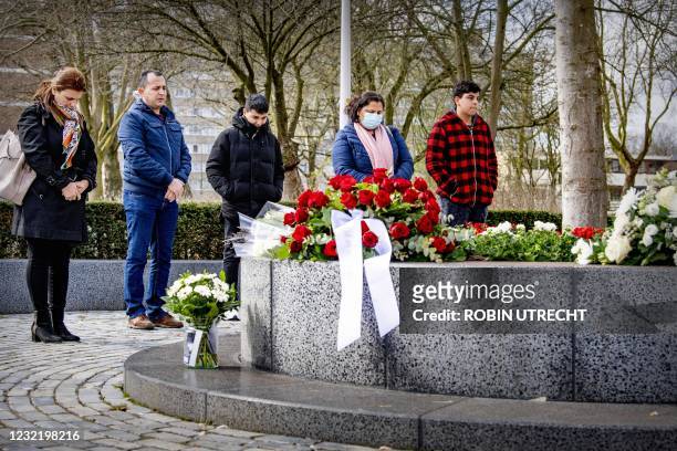 People lay flowers at a memorial for those killed at the Ridderhof shopping center in 2011, some 33 kilometers southwest of Amsterdam, on April 9,...