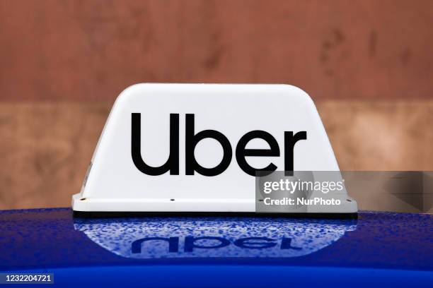 Uber Taxi sign is seen on the roof of the car in Krakow, Poland on April 7, 2021.