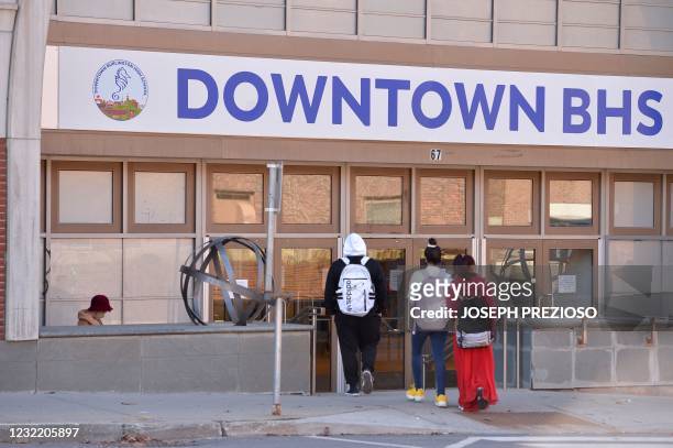 Students enter their new Downtown Burlington High School at a closed Macy's department store in Burlington, Vermont on March 30, 2021. - Vermont...