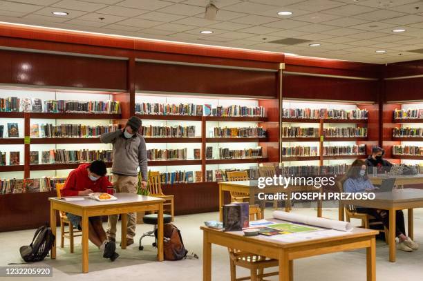 Students from the new Downtown Burlington High School work inside the fine China department at a closed Macy's department store tranformed in a...