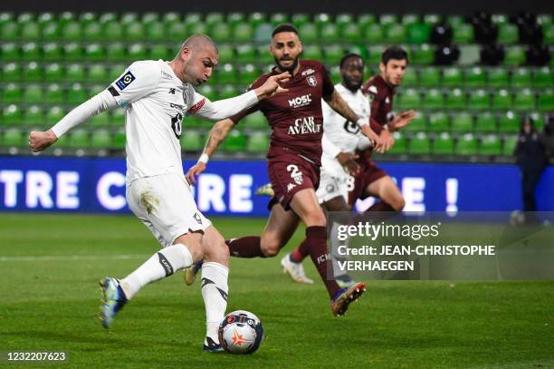 Lille's Turkish forward Burak Yilmaz shoots and scores a goal during the French L1 football match between Metz and Lille at Saint Symphorien stadium...