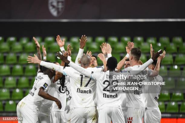 Lille's players celebrate after scoring a goal during the French L1 football match between Metz and Lille at Saint Symphorien stadium in...