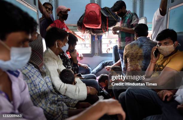 Migrants on board a train from Mumbai to Varanasi at Lokmanya Tilak Terminus on April 9, 2021 in Mumbai, India. Amid the surge in Covid-19 cases in...