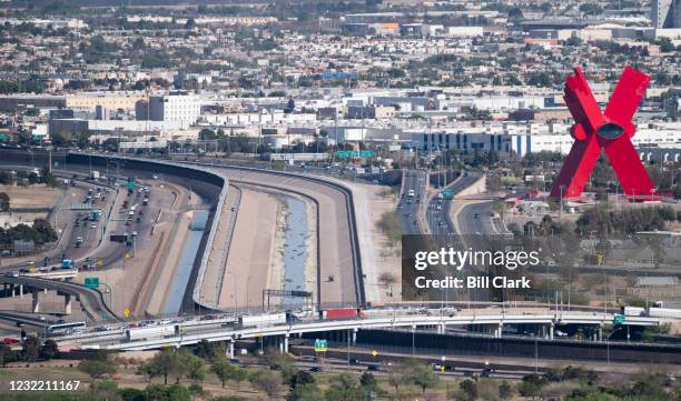 Trucks and cars cross over the Rio Grande and U.S. Mexico border on the Bridge of the Americas in El Paso, Texas on Friday, April 9, 2021.