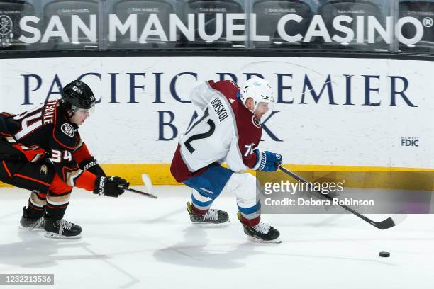 Joonas Donskoi of the Colorado Avalanche skates with the puck ahead of Jacob MacDonald of the Colorado Avalanche in the third period at Honda Center...