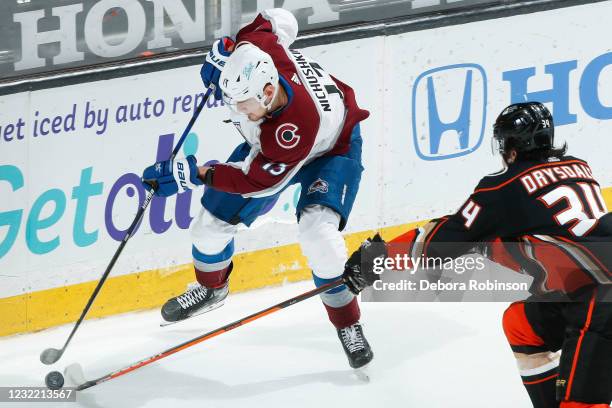 Valeri Nichushkin of the Colorado Avalanche and Jamie Drysdale of the Anaheim Ducks go for the puck at Honda Center on April 09, 2021 in Anaheim,...