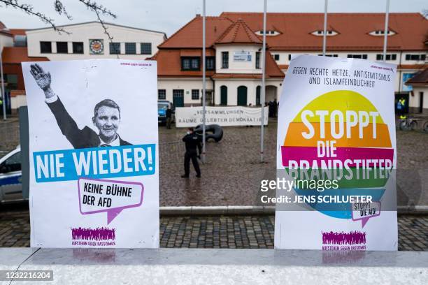 Placards reading 'Stop the arsonists' and showing Thuringia's leader of Alternative for Germany party Bjoern Hoecke with the lettering 'Never again'...