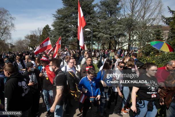 Participants with flags and banners attend an unauthorized demonstration against the anti-corona measures in Vienna on April 10, 2021 amid the novel...