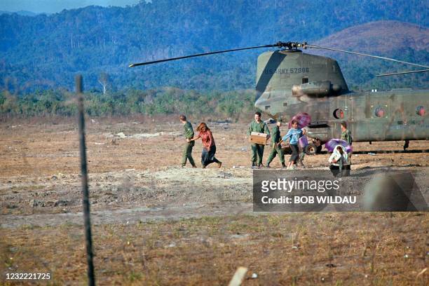 An US observation military plane is stationed at the US Advisory compound in the Kon Tum Province, where mountain girls sell beers and souvenirs to...