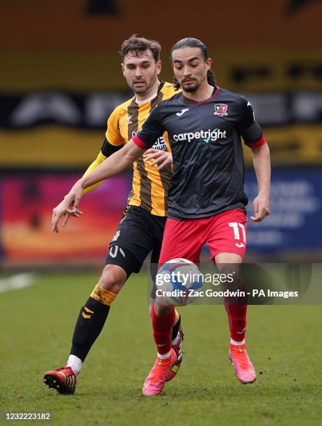 Cambridge United's Greg Taylor and Exeter City's Randell Williams battle for the ball during the Sky Bet League Two match at the Abbey Stadium,...