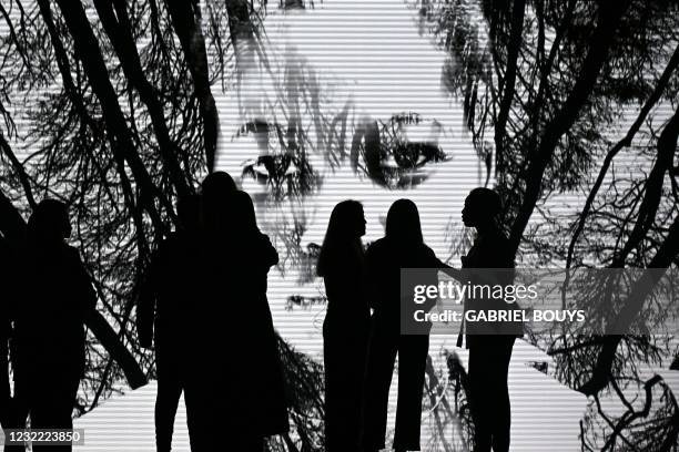 Attendees chat on the catwalk prior to the presentation of Spanish designer Ulises Merida's Autumn - Winter 2021 / 2022 collection during the...