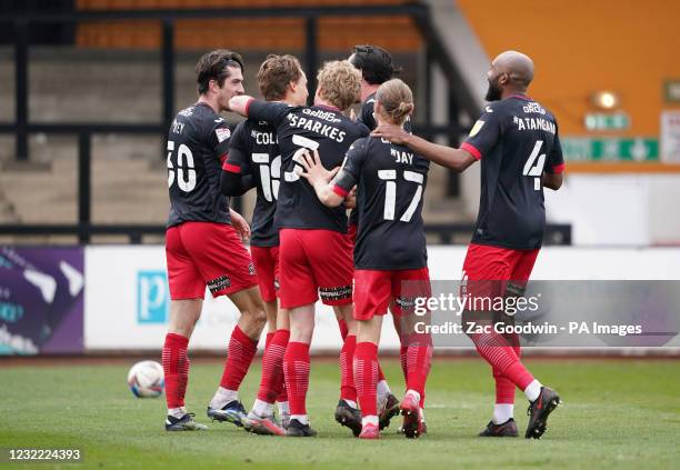 Exeter City's Archie Collins celebrates with teammates after scoring his sides third goal during the Sky Bet League Two match at the Abbey Stadium,...