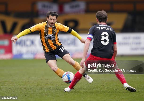 Cambridge United's Wesley Hoolahan and Exeter City's Jake Taylor battle for the ball during the Sky Bet League Two match at the Abbey Stadium,...
