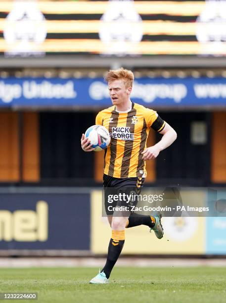Cambridge United's Liam O'Neil collects the ball after scoring his sides first goal during the Sky Bet League Two match at the Abbey Stadium,...