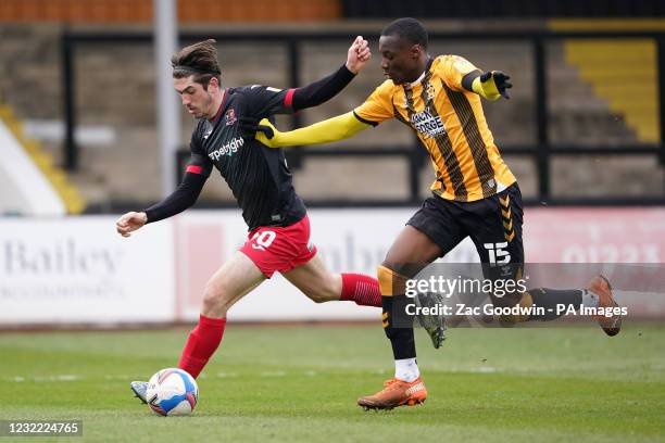 Cambridge United's Jubril Okedina and Exeter City's Joshua Key battle for the ball during the Sky Bet League Two match at the Abbey Stadium,...