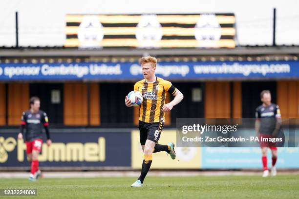 Cambridge United's Liam O'Neil collects the ball after scoring his sides first goal during the Sky Bet League Two match at the Abbey Stadium,...