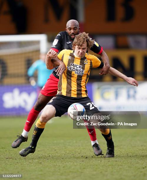 Cambridge United's Joe Ironside and Exeter City's Nigel Atangana battle for the ball during the Sky Bet League Two match at the Abbey Stadium,...